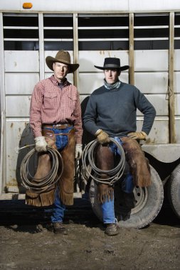 Two Men Wearing Cowboy Hats Holding Lariats clipart