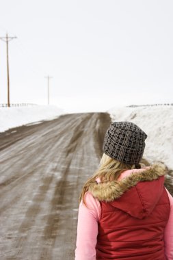 Woman looking down road. clipart