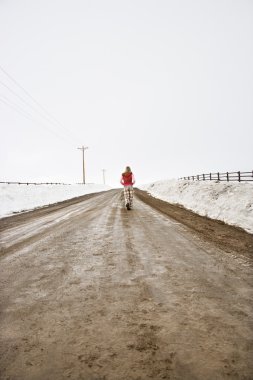 Woman walking down road. clipart