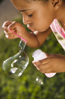 Young Girl Blowing Bubbles clipart