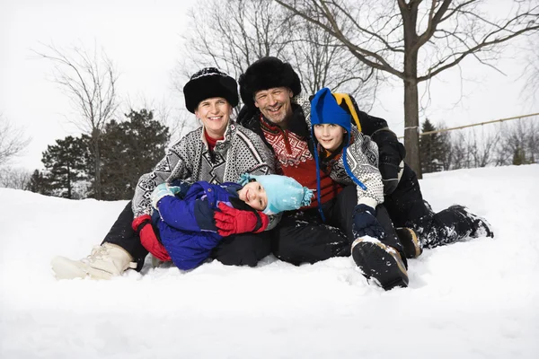 Family sitting in snow. — Stock Photo, Image