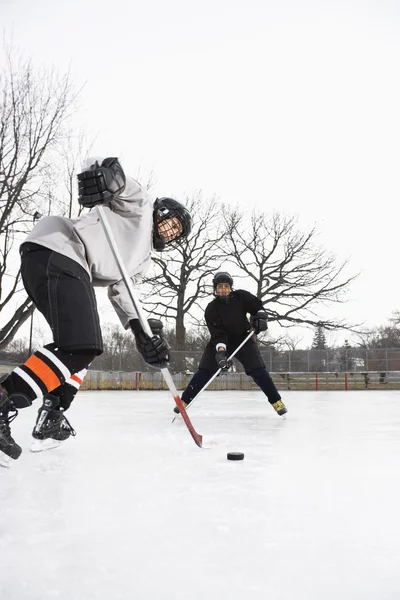 Boys playing ice hockey. — Stok fotoğraf