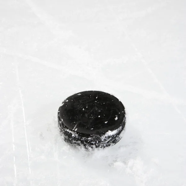 Hockey puck on ice. — Stock Photo, Image