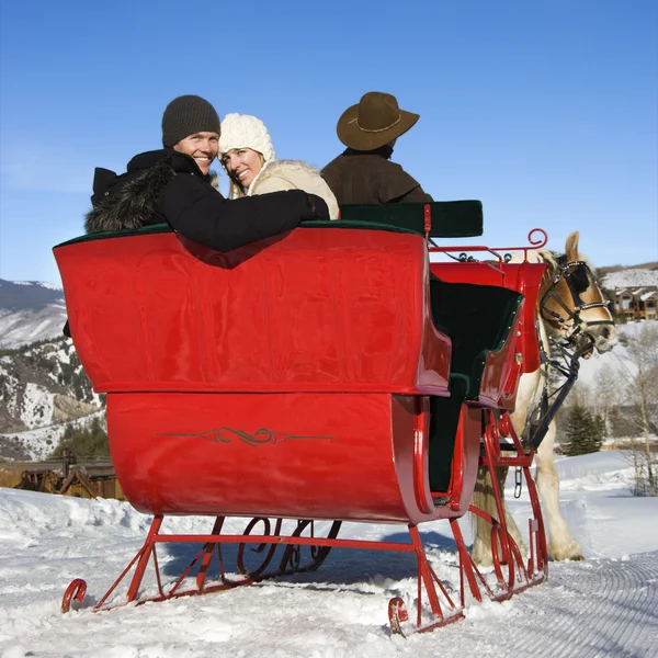 Young couple on sleigh ride. — Stock Photo, Image