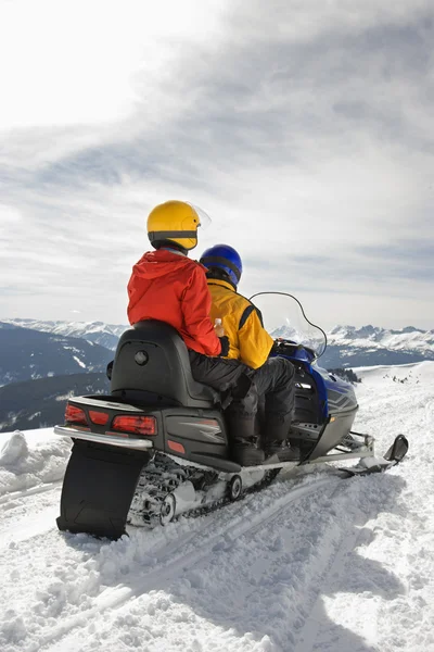 Couple on snowmobile. — Stock Photo, Image