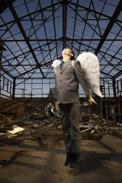 Młody biznesmen z anielskimi skrzydłami — Zdjęcie stockowe