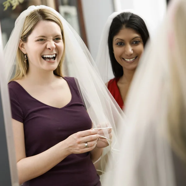 Friends trying on veils. — Stock Photo, Image