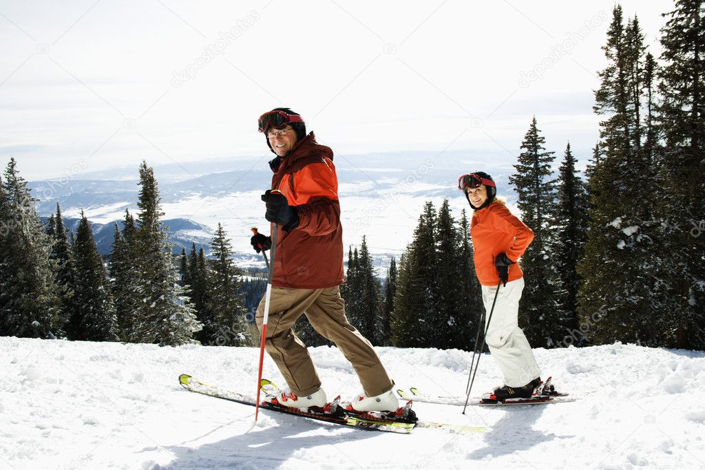 Couple Skiing on Mountain Slope