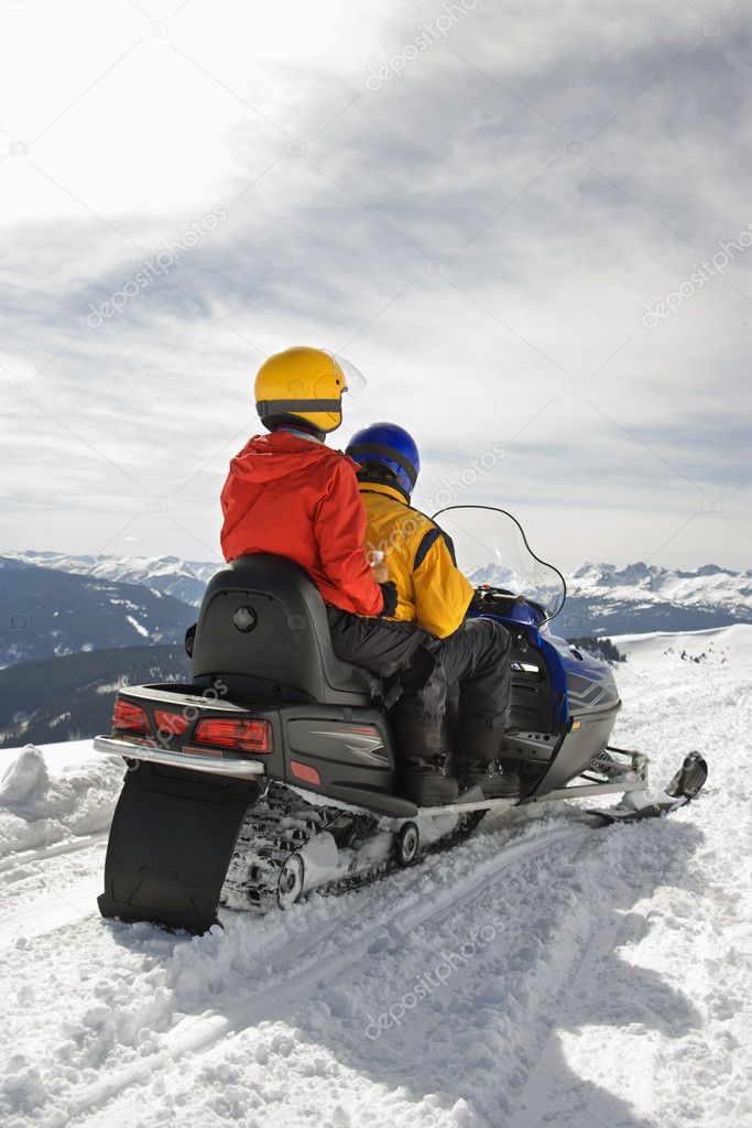 Couple on snowmobile.