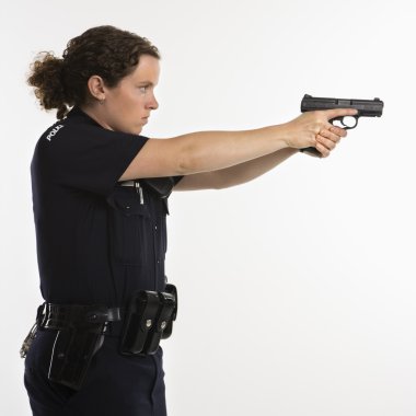 Policewoman aiming gun. clipart