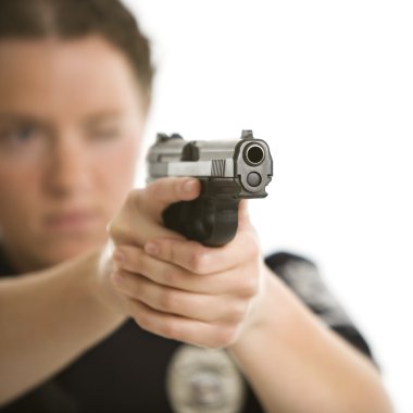 Policewoman aiming gun. clipart