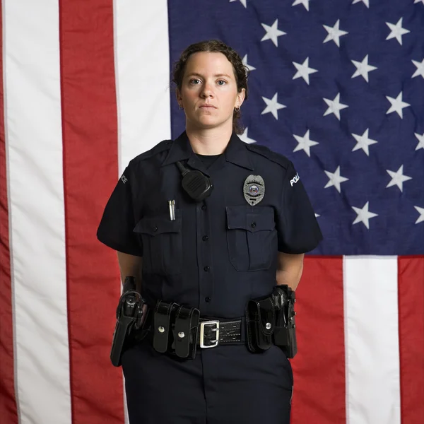 Mujer policía y bandera . —  Fotos de Stock