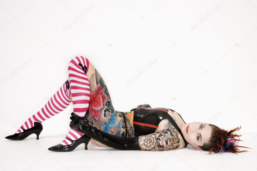Tattooed woman lying down