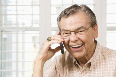 Mature man on cellphone. clipart