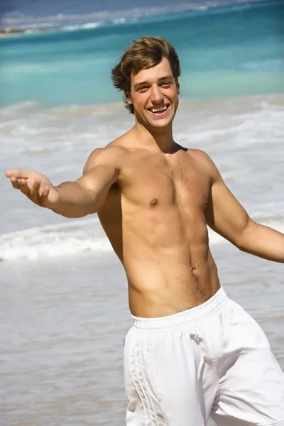 Usmívající se muž na pláži. — Stock fotografie