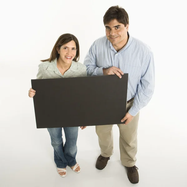 Couple holding blank sign. — Stock Photo, Image