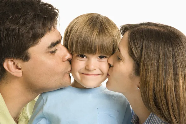 Parents kissing son. Royalty Free Stock Images