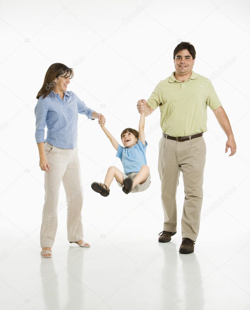 Parents swinging son.