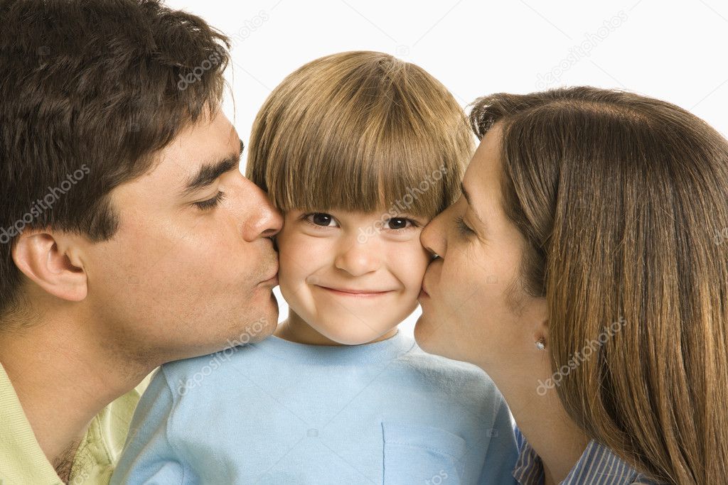Parents kissing son.