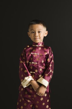 Asian boy in traditional attire. clipart