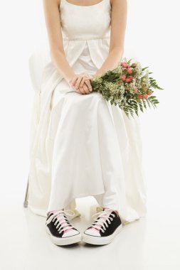 Bride wearing sneakers. clipart