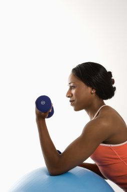 Profile woman lifting dumbbell. clipart