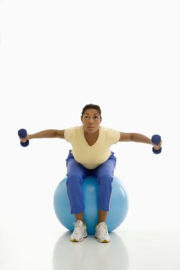 Woman exercising on ball. clipart