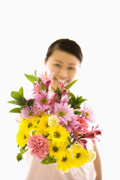 Asian woman holding flowers. — Stock Photo, Image