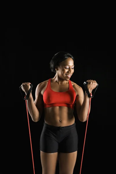 Woman stretching resistance tube. — Stock Photo, Image