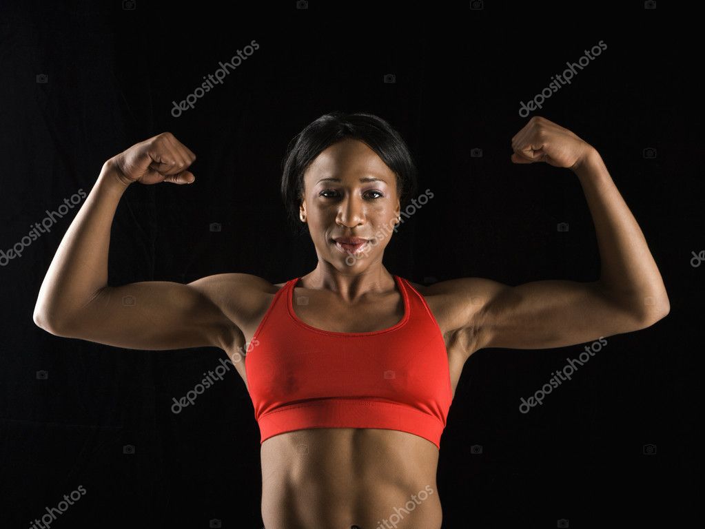 Woman flexing her biceps hi-res stock photography and images