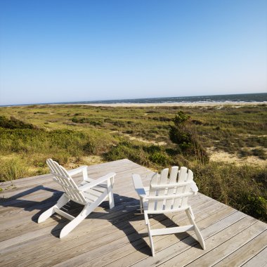 Deck chairs on beach. clipart