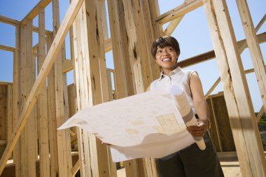 Woman Holding Building Plans clipart