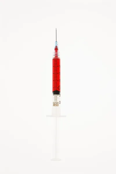 Needle with red liquid. — Stock Photo, Image