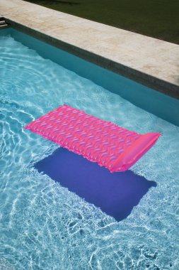 Pink float in pool. clipart