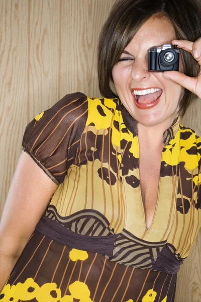 Woman and miniature camera. — Stock Photo, Image