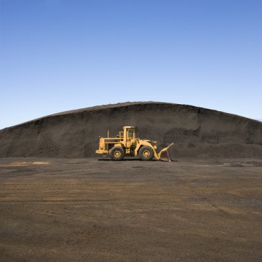 Bulldozer and dirt mound. clipart