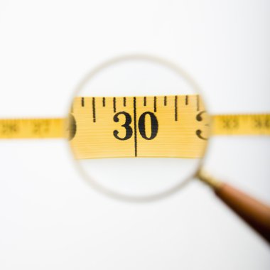 Magnifyed measuring tape. clipart