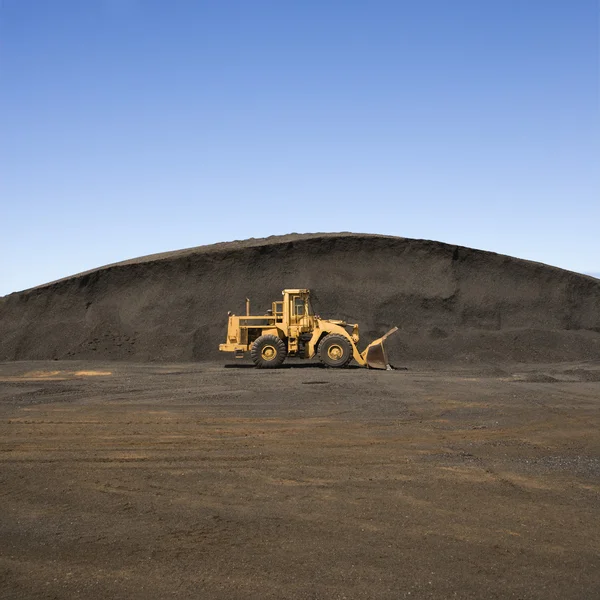 Bulldozer and dirt mound. — Stock Photo, Image