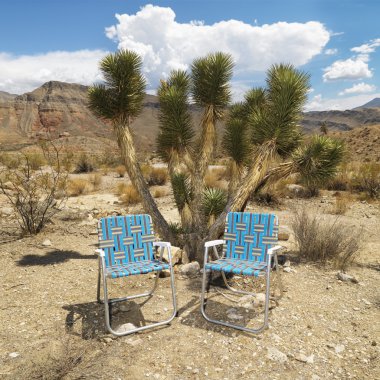 Empty chairs in desert. clipart