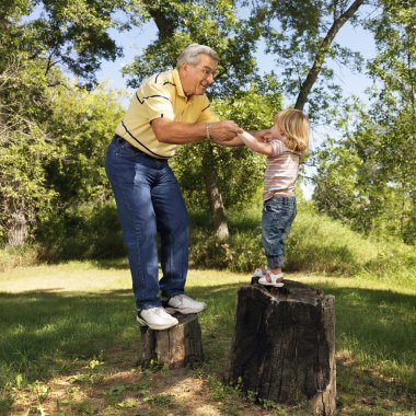 Senior man and child playing. clipart