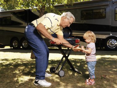 Man and child with hotdog. clipart