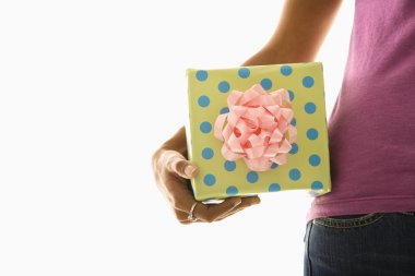 Woman holding gift. clipart