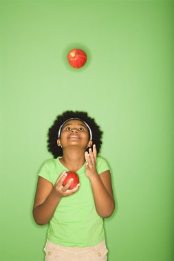 Girl juggling apples. clipart