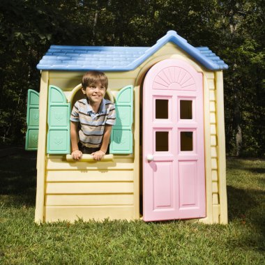 Boy in playhouse. clipart
