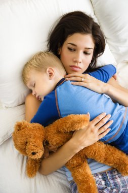 Mom with sleeping child. clipart