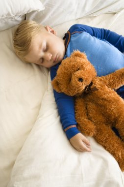 Child sleeping with teddy. clipart