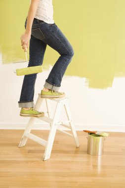 Female painter on ladder. clipart