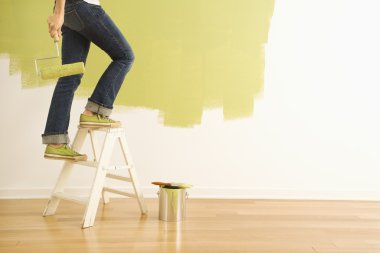 Woman painter on ladder. clipart