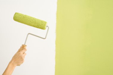 Woman painting wall. clipart