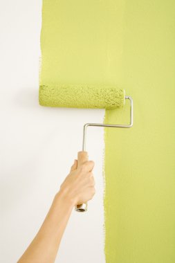 Woman painting wall. clipart